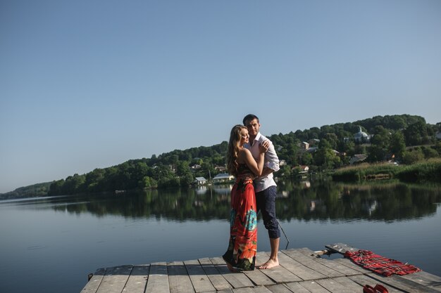 Couple embracing with a lake and a mountain background