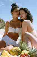 Free photo couple enjoying a picnic together outdoors in summertime