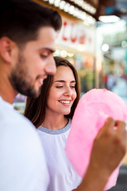 Couple enjoying pink cotton candy