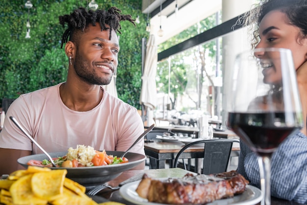 Couple enjoying and spending good time together while having a date at a restaurant.