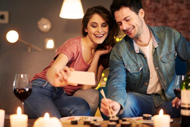 Couple enjoying sushi together at home interior