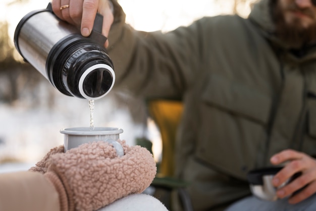 Free photo couple enjoying their winter camp