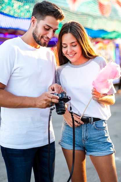 Free photo couple at fair looking at camera