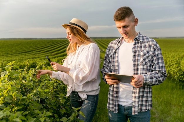 couple at farm with tablet