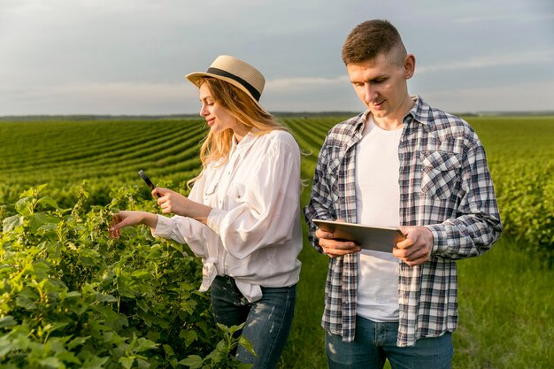 Couple at farm with tablet