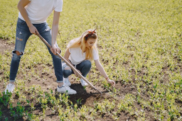 Couple farming in agricultural field