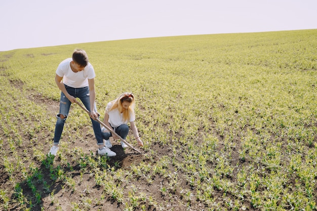 Couple farming in agricultural field