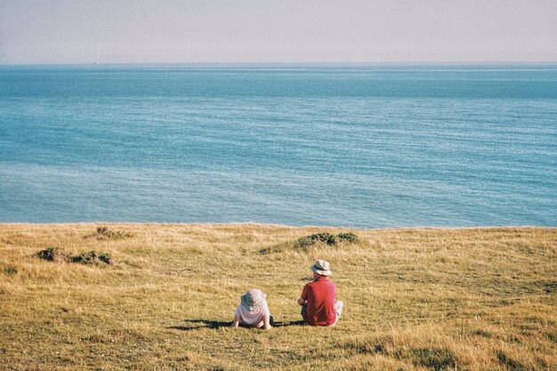 Couple in the field looking the sea