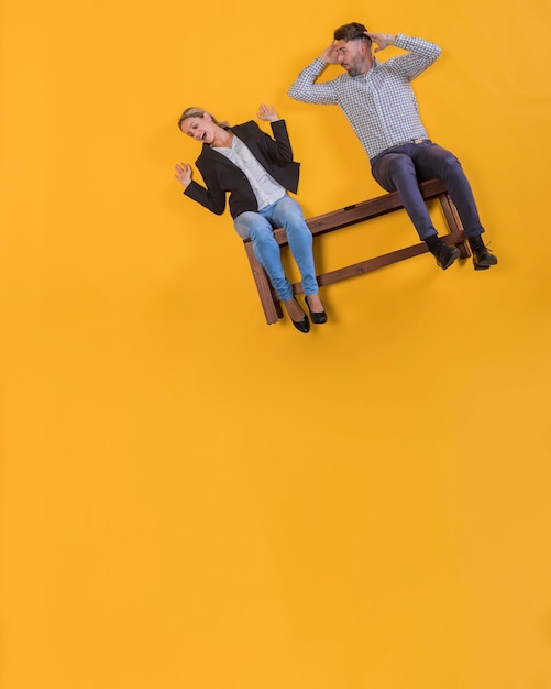 Free photo couple floating on a bench