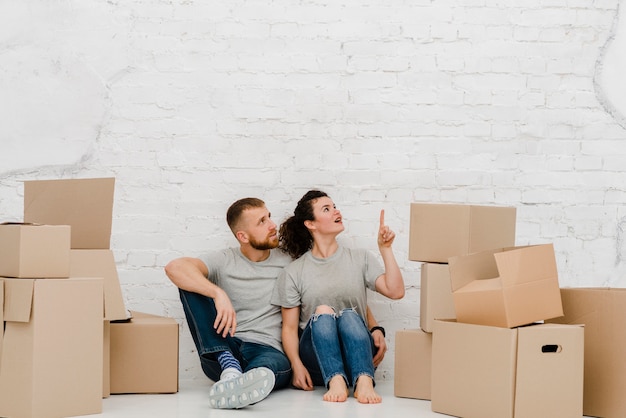 Couple on floor pointing up