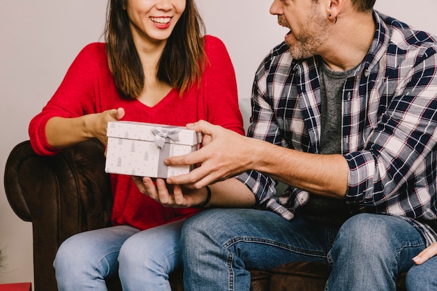 Free photo couple gifting each other