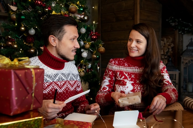 Couple giving each other christmas gifts