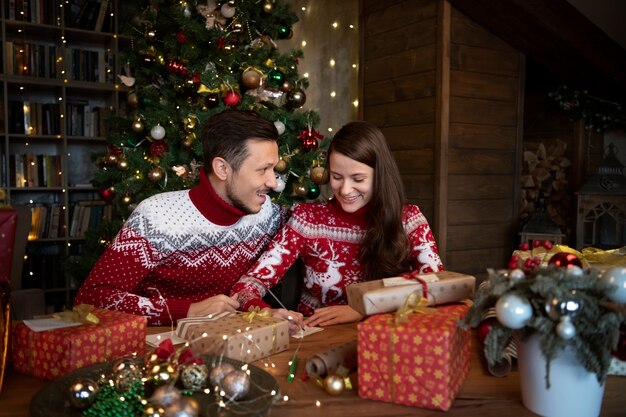 Couple giving each other christmas gifts