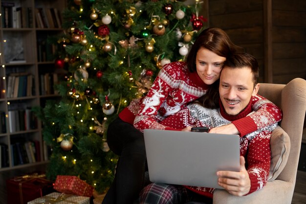 Couple giving each other christmas gifts