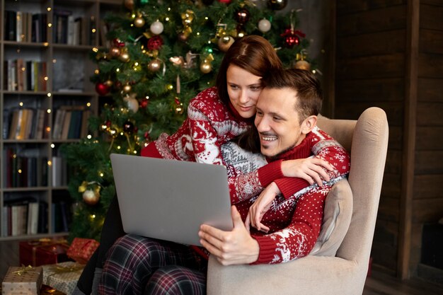 Couple giving each other christmas gifts