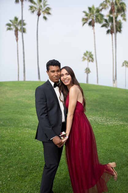 Couple in graduation prom clothing outdoors