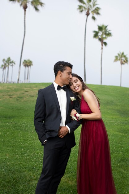 Couple in graduation prom clothing outdoors