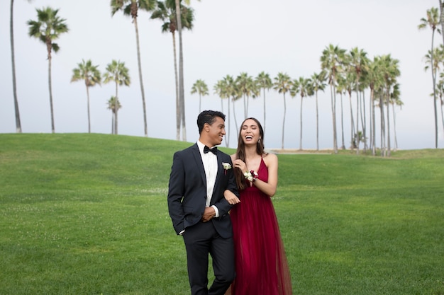 Free photo couple in graduation prom clothing outdoors