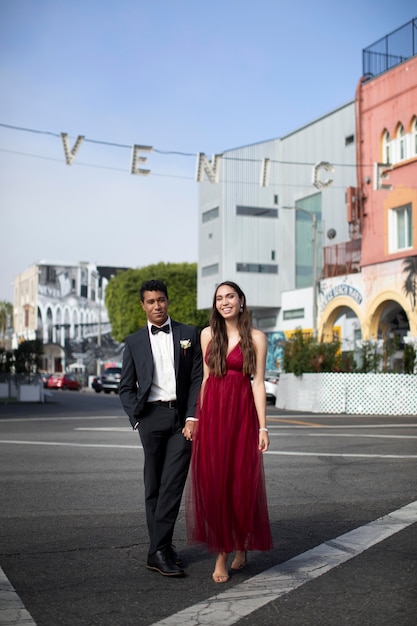 Free photo couple in graduation prom clothing posing together