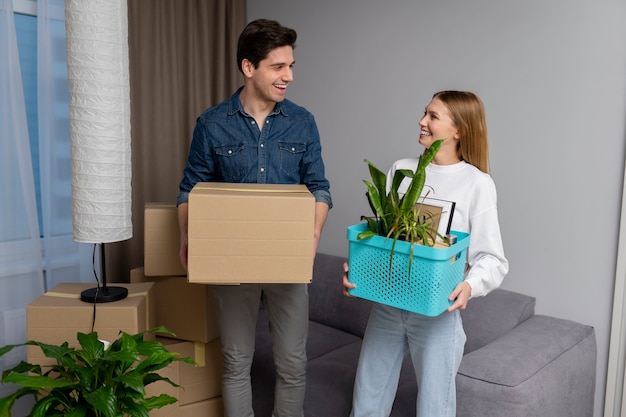 Couple handling belongings after moving in new home