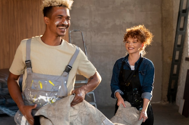 Free photo couple handling a carpet together in their new home