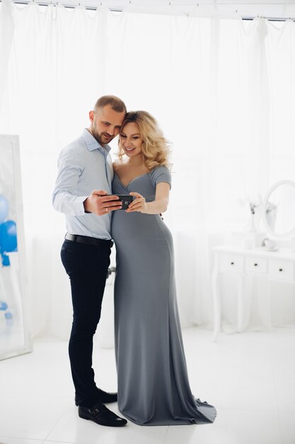 Couple handsome man and pregnant woman taking self portrait