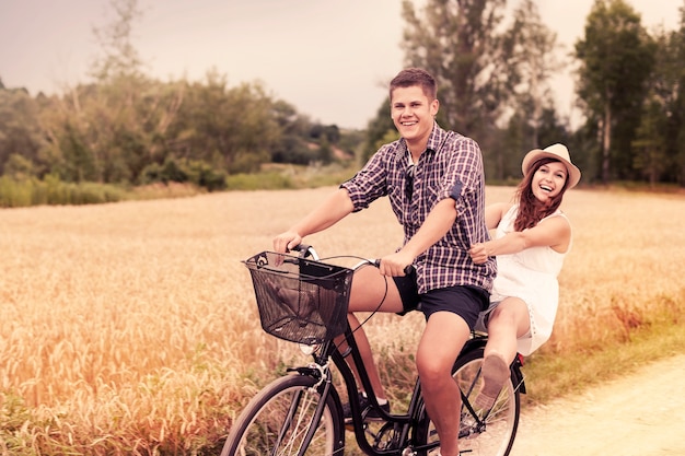 Couple have fun riding on bike