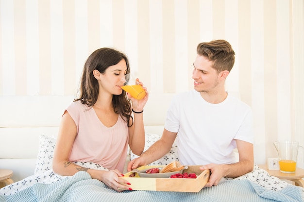 Couple having breakfast in bed