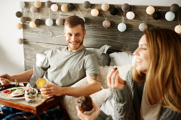 Couple having breakfast in bed