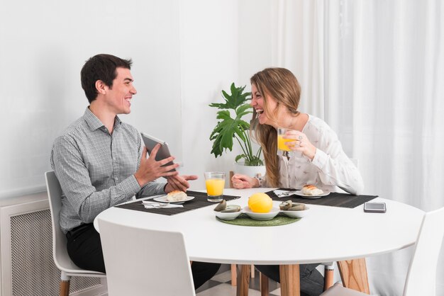 Couple having breakfast and talking at home