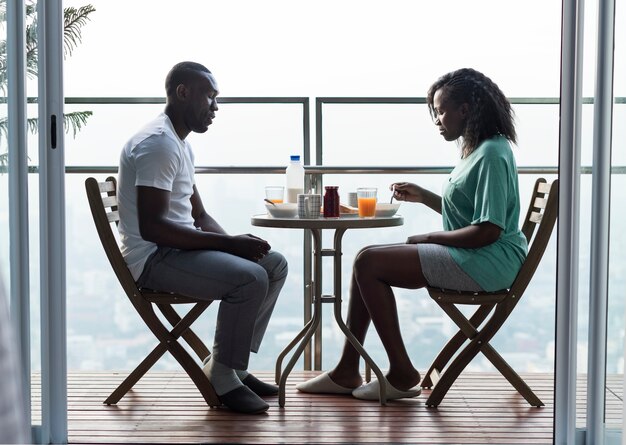 Couple having breakfast together at the balcony