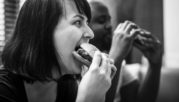 Couple having fast food on the couch