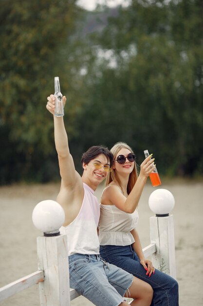 Couple having fun on a beach with drinks