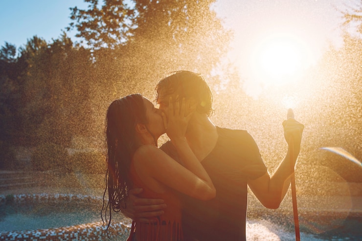 Free Photo couple having fun pour each other with garden hose