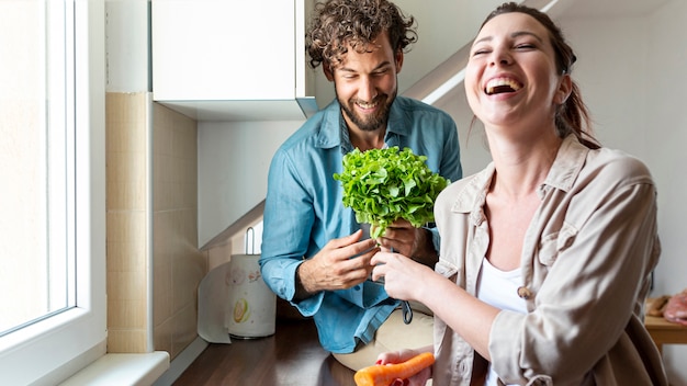 Free photo couple having fun while cooking dinner