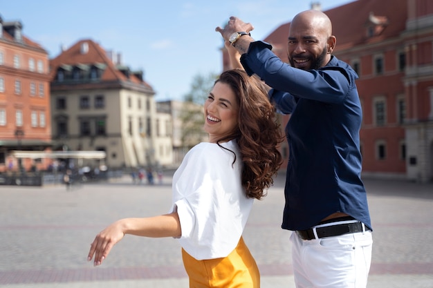 Couple having fun while dancing in the city