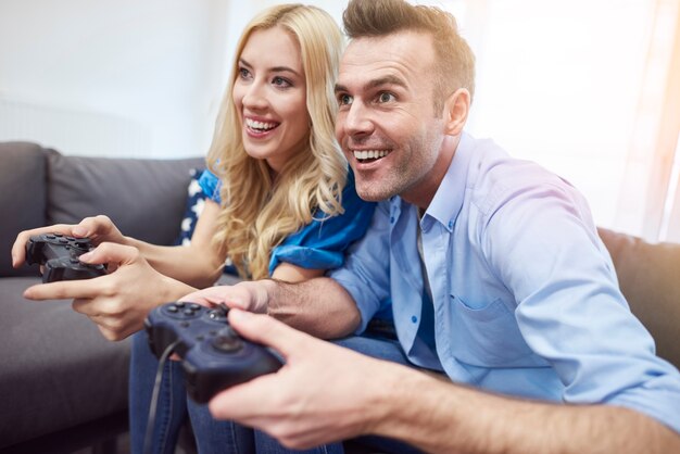 Couple having fun while playing video game