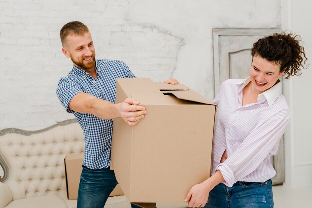 Couple having fun with carton box