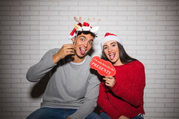 Couple having fun with Christmas decorations 