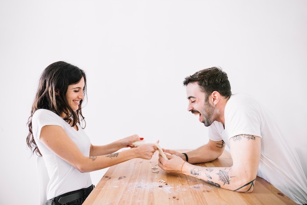 Free photo couple having fun with dough