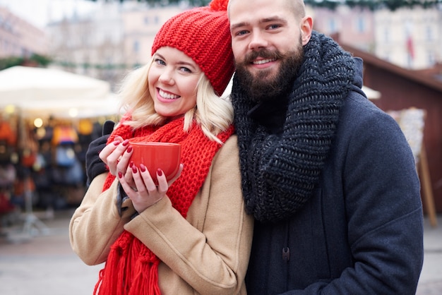 Couple having hot coffee outdoors