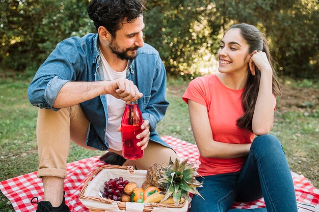 Free photo couple having a picnic in nature