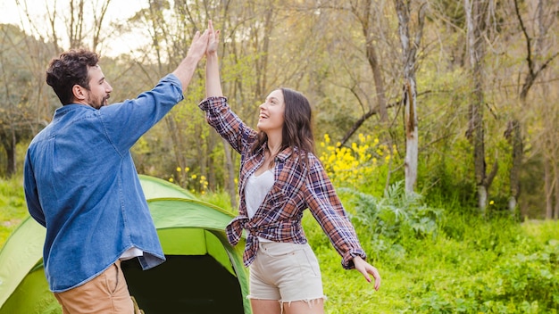 Couple high-fiving near tent