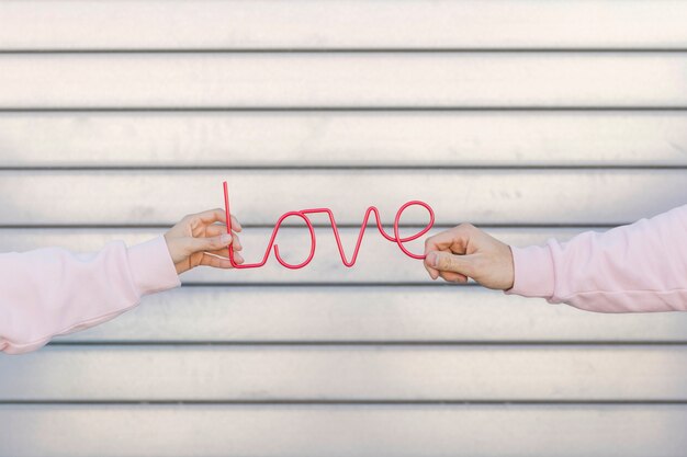 Couple holding decorative love sign