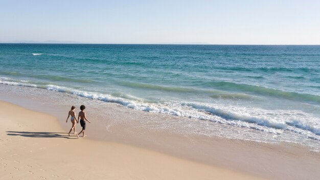 Couple holding hands and going to sea