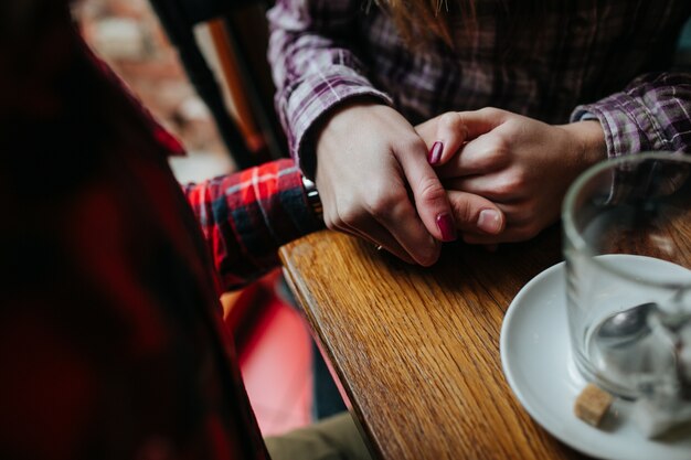 Couple holding hands sitting in a bar