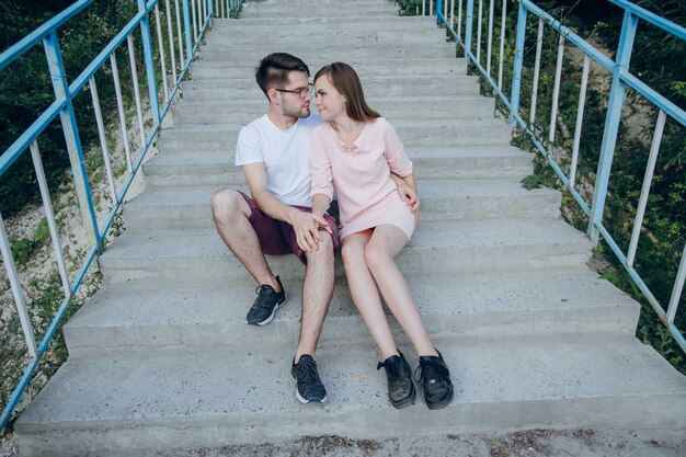 Couple holding hands sitting on stairs