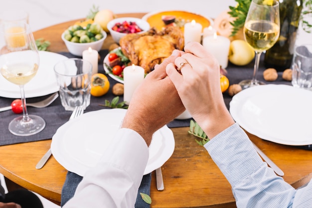 Couple holding hands at table