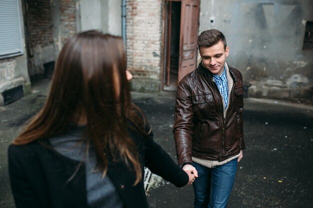 Couple holding hands walking in city