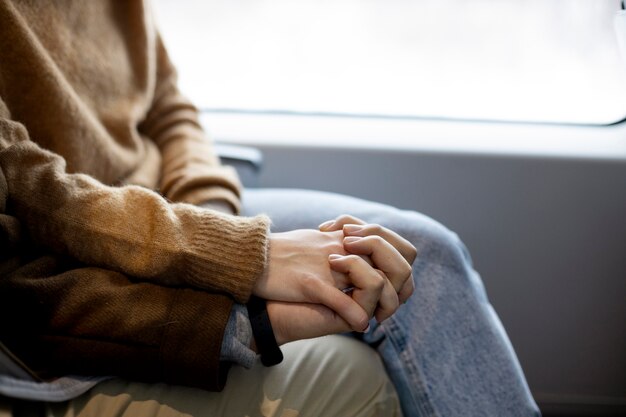 Couple holding hands while traveling by train